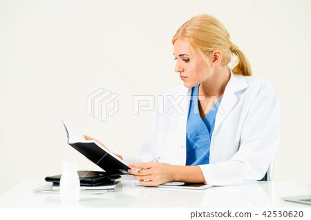 Doctor in hospital working on medical report. 42530620
