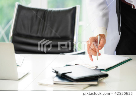 Young man doctor working at office in hospital. Young man doctor working at office in hospital. 42530635