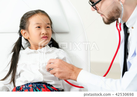 Doctor examining little happy kid in hospital. Doctor examining little happy kid in hospital. 42530698