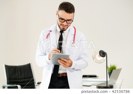 Doctor working on tablet computer in the hospital. 42530786