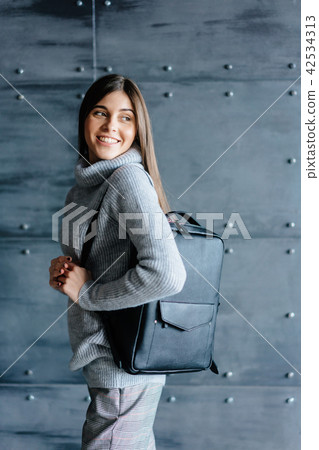Fashionable woman hold black bag 42534313
