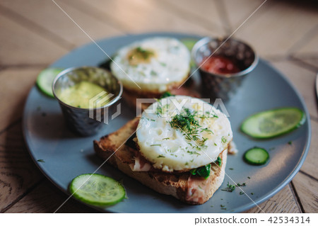 Plate with morning breakfast on the table 42534314