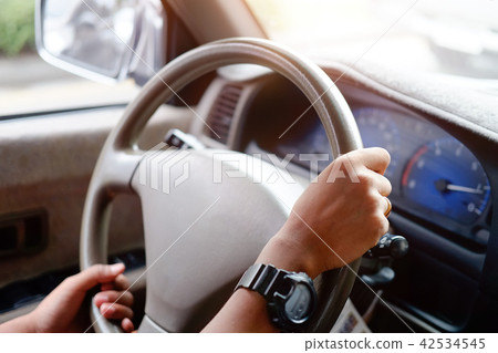 Close up driver in a car with morning light. 42534545
