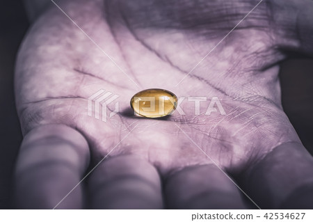 Gelatine Pill In A Dirty And Used Looking Hand Gelatine Pill In A Dirty And Used Looking Hand 42534627