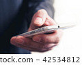 Macro Of A Businessman Touching White Mobile Phone 42534812