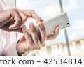 Male Hands Touching A White Mobile Phone 42534814