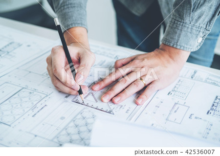 Architect or engineer working in office blueprint 42536007