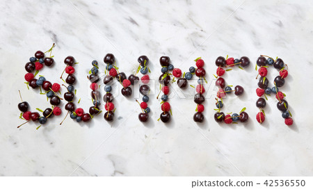 Summer background with summer berries - word "SUMMER" from cherry, raspberry, blueberries on gray Summer background with summer berries - word "SUMMER" from cherry, raspberry, blueberries on gray 42536550