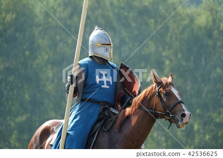 medieval knight with a spear riding a horse 42536625