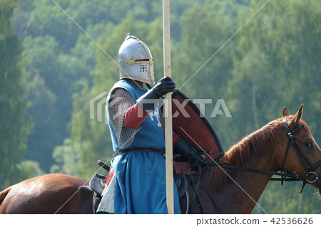 medieval knight with a spear riding a horse 42536626