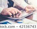 Businessman Analyzing Statistics With Tablet 42536743