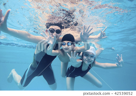 Coach and children enjoying swimming Coach and children enjoying swimming 42539052