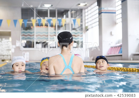 Swimming coach and children Swimming coach and children 42539083