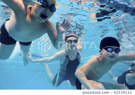 Coach and children enjoying swimming Coach and children enjoying swimming 42539132