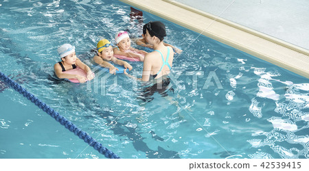 Swimming coach and children Swimming coach and children 42539415