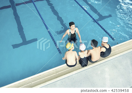 Swimming coach and children Swimming coach and children 42539458
