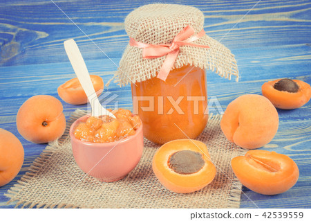 Fresh apricot marmalade and fruits on blue boards 42539559
