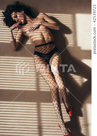 Naked sexy woman lying on the floor. Nude body. 42539723