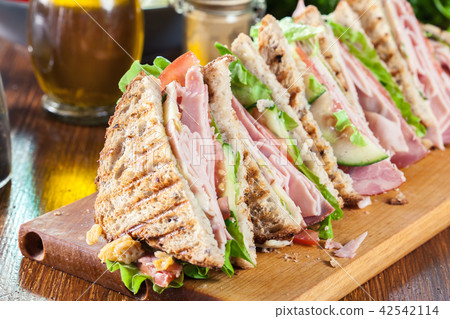 Sandwiches with ham, cheese, tomatoes and cucumber Sandwiches with ham, cheese, tomatoes and cucumber 42542114