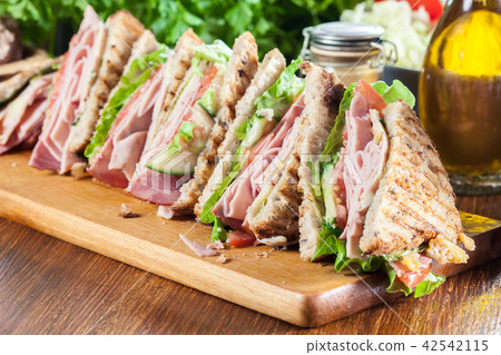 Sandwiches with ham, cheese, tomatoes and cucumber Sandwiches with ham, cheese, tomatoes and cucumber 42542115