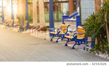 Coloured yellow and blue benches on promenade 42542826