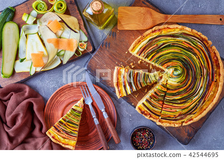 Spiral tart with zucchini, eggplant, carrot Spiral tart with zucchini, eggplant, carrot 42544695
