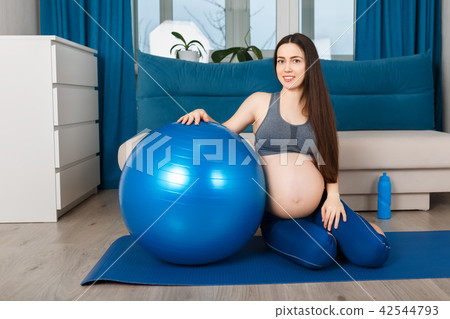 pregnant woman with fit ball at home 42544793