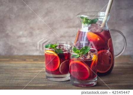 A pitcher and two glasses with Spanish Sangria 42545447