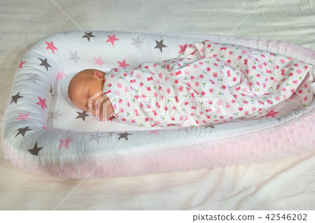 Newborn baby sleeping wrapped in blanket. Newborn baby sleeping wrapped in blanket. 42546202