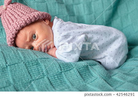 Newborn surprised baby girl in bed. Newborn surprised baby girl in bed. 42546291