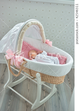 Newborn little baby in moses basket. 42546311