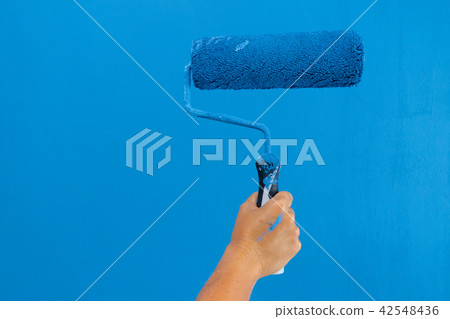Someone painting wall Someone painting wall 42548436