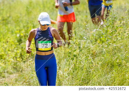 Young slim woman running trail race contest 42551672