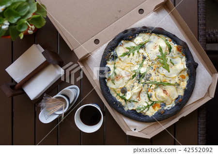 Black pizza four cheese with coffee top view image 42552092