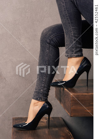 legs in high-heeled shoes on cantilever ladder legs in high-heeled shoes on cantilever ladder 42552461