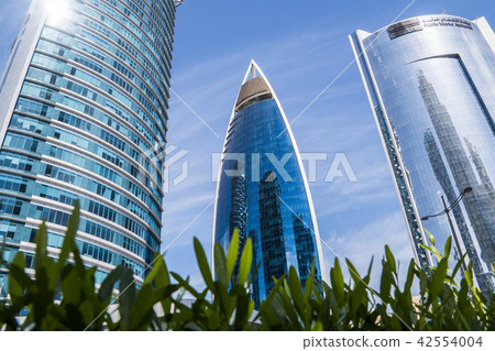 DOHA, QATAR - FEB 2018: Wide Angle Shot of Modern Blue High Skyscrapers in Doha city, Qatar. DOHA, QATAR - FEB 2018: Wide Angle Shot of Modern Blue High Skyscrapers in Doha city, Qatar. 42554004