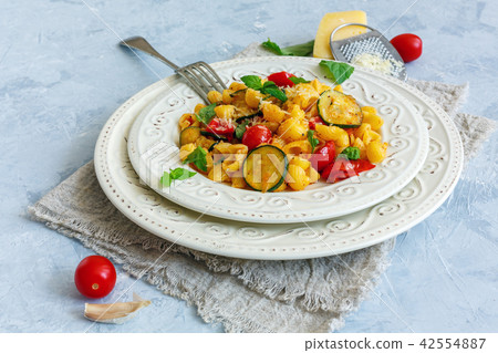 Traditional pasta with tomatoes and zucchini. Traditional pasta with tomatoes and zucchini. 42554887