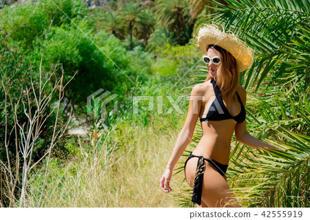 girl in bikini and hat have rest in palm forest 42555919