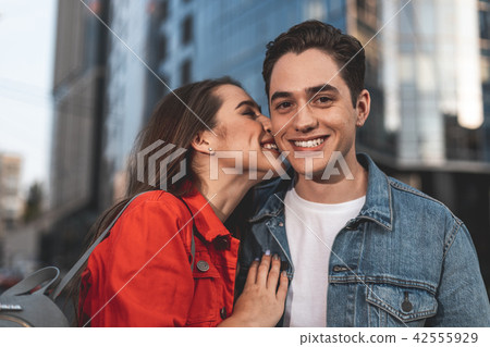 Loving young man and woman standing on street Loving young man and woman standing on street 42555929