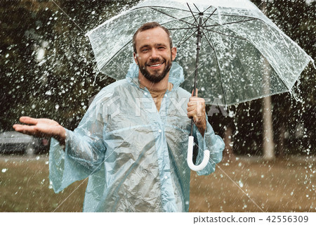 Positive man being happy in rain 42556309