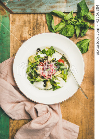 Fresh green summer salad with artichokes in white plate Fresh green summer salad with artichokes in white plate 42556884