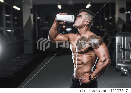 Handsome strong bodybuilder men pumping up muscle 42557247