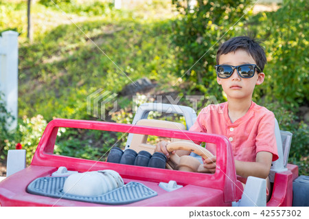 Young Mixed Race Chinese and Caucasian Boy Wearing Sunglasses Pl Young Mixed Race Chinese and Caucasian Boy Wearing Sunglasses Pl 42557302