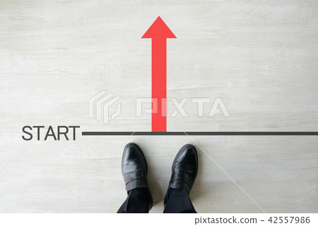 A businessman standing on the start line A businessman standing on the start line 42557986