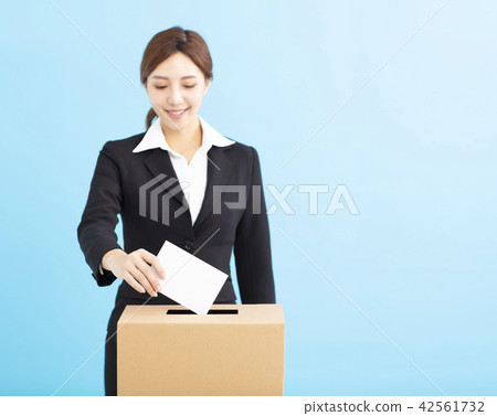 young Woman putting  ballot into voting box 42561732