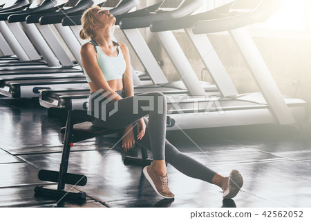 young woman taking a break after exercise at gym young woman taking a break after exercise at gym 42562052