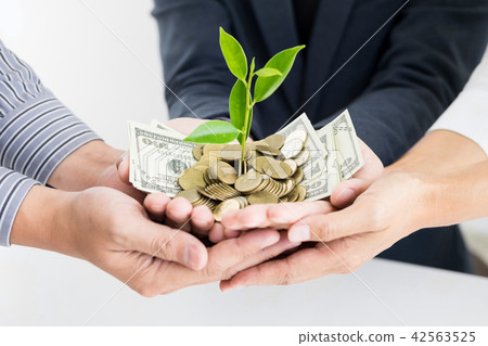 Business man hand make palm up with growing up money coins and s Business man hand make palm up with growing up money coins and s 42563525
