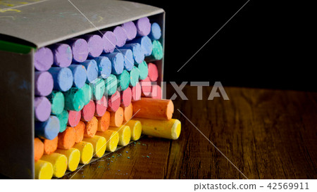 Multi color chalks on black background Multi color chalks on black background 42569911