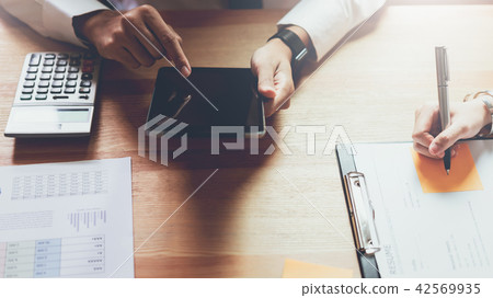 Businessman working on tablet design ideas. 42569935