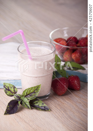Smoothies with strawberries and basil in a glass Smoothies with strawberries and basil in a glass 42570607